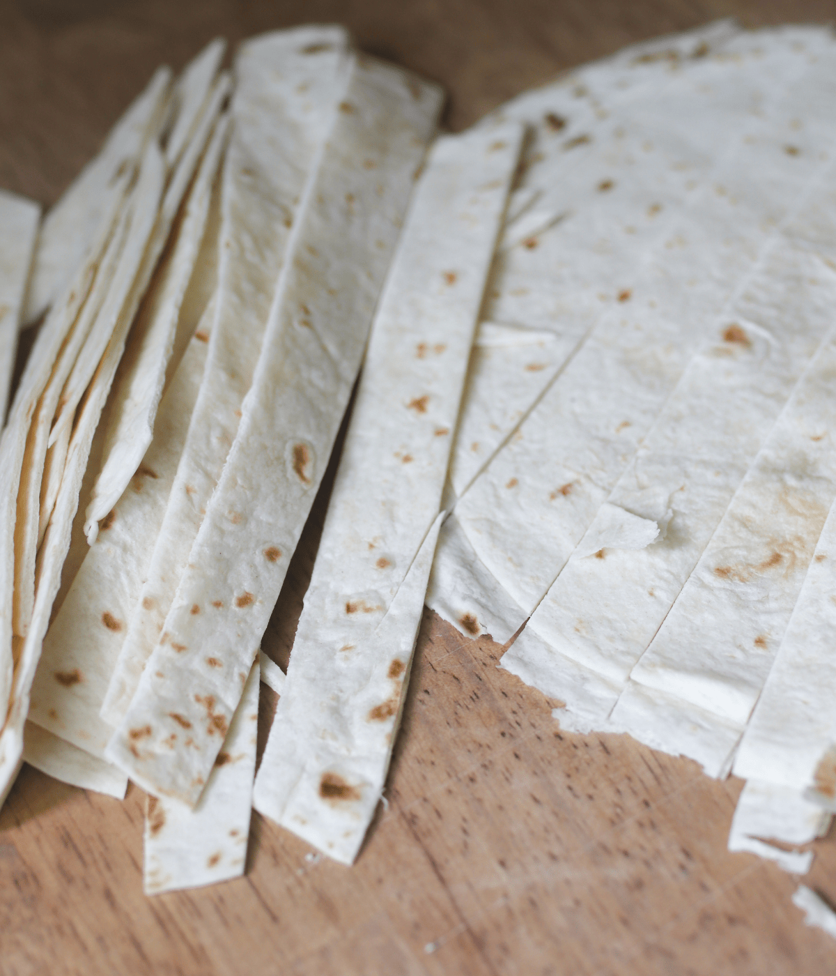 slicing homemade tortilla strips for white chicken chili
