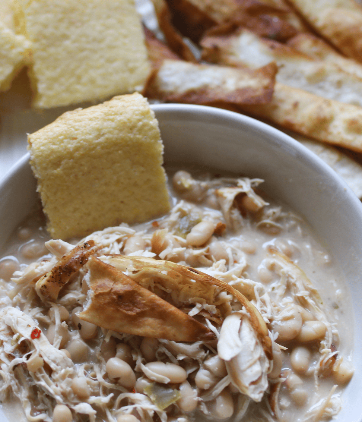 White chicken chili served hot with crunchy tortilla strips on top